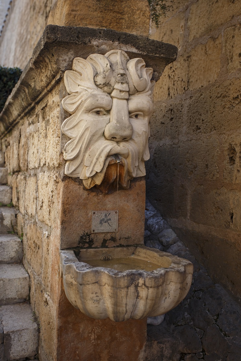 A really nice but unremarkable fountain at the edge of a staircase. 
