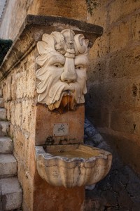 A really nice but unremarkable fountain at the edge of a staircase.